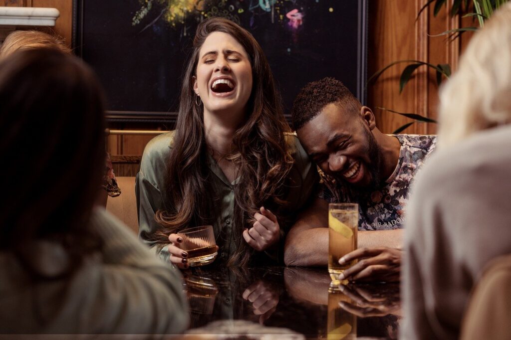 friends laughing with drinks